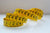 A yellow flexible measuring tape wound in spirals.