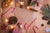 Candy canes, presents, acorns, pine cones, and fairy lights spread on a wooden surface.