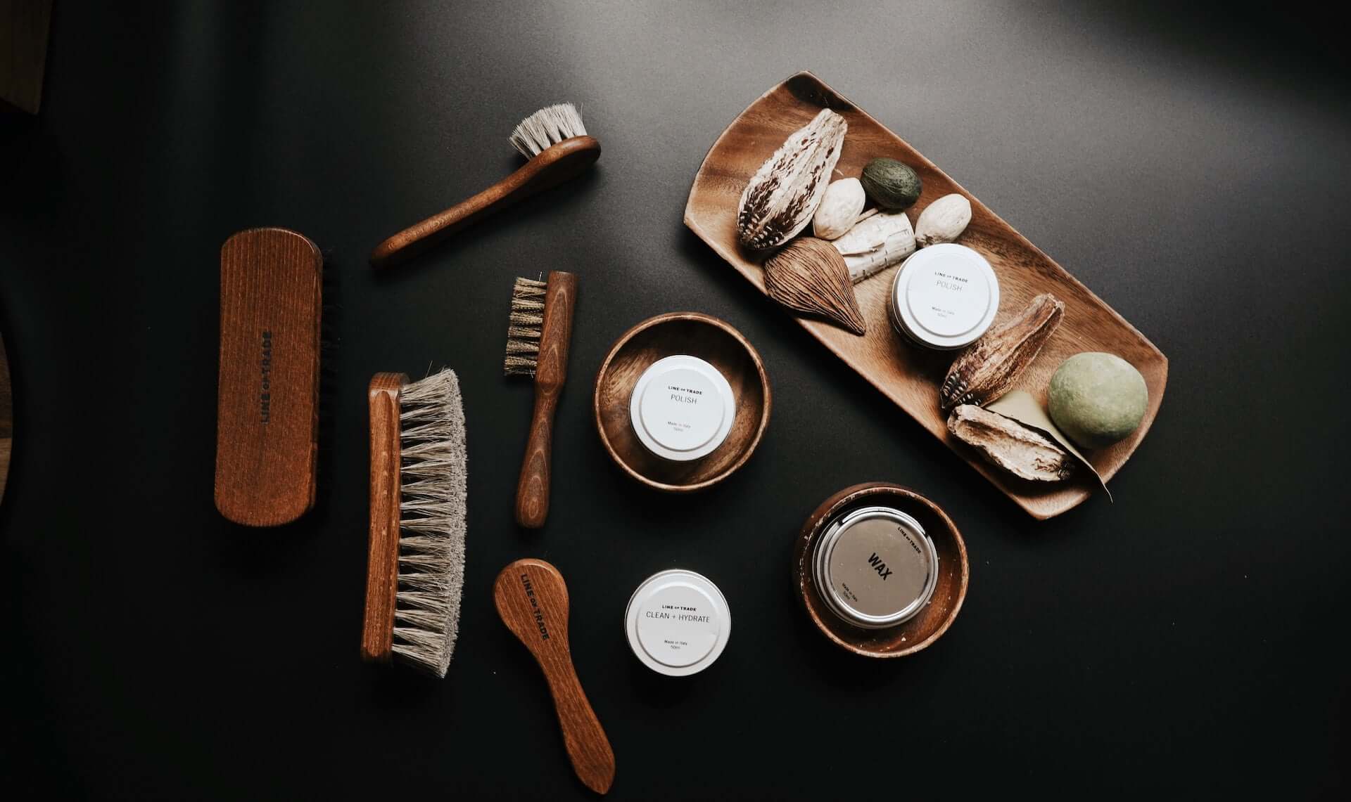 A range of leather care products including brushes and balms.