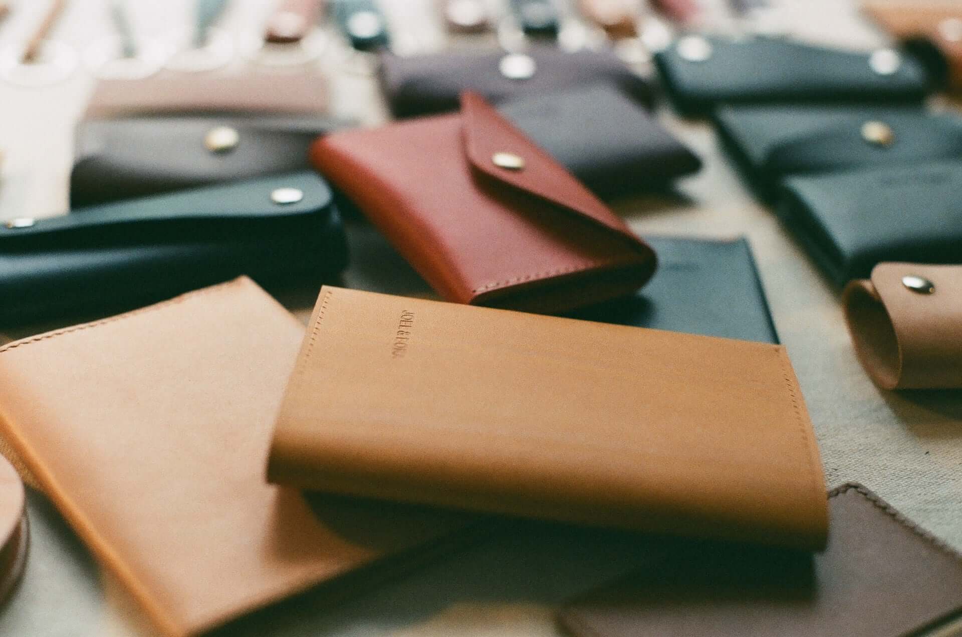 Leather clutch wallets in various colors.