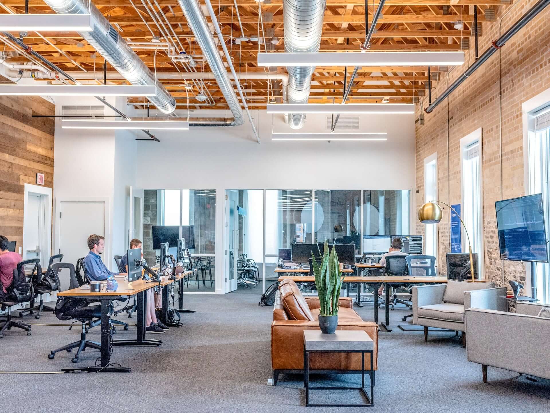 An open plan office in an industrial-style building.