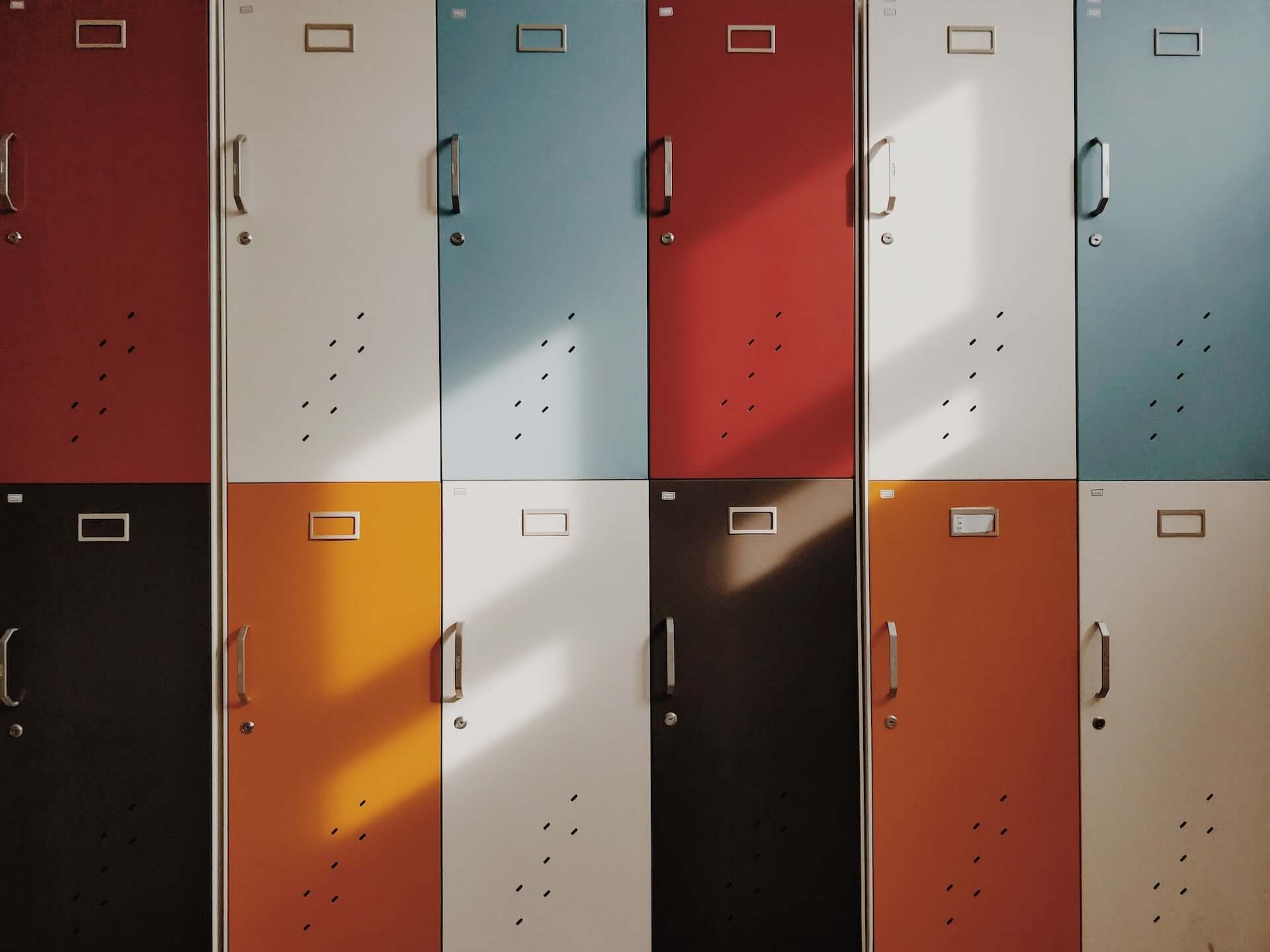 Two rows of multicolored half-length lockers.