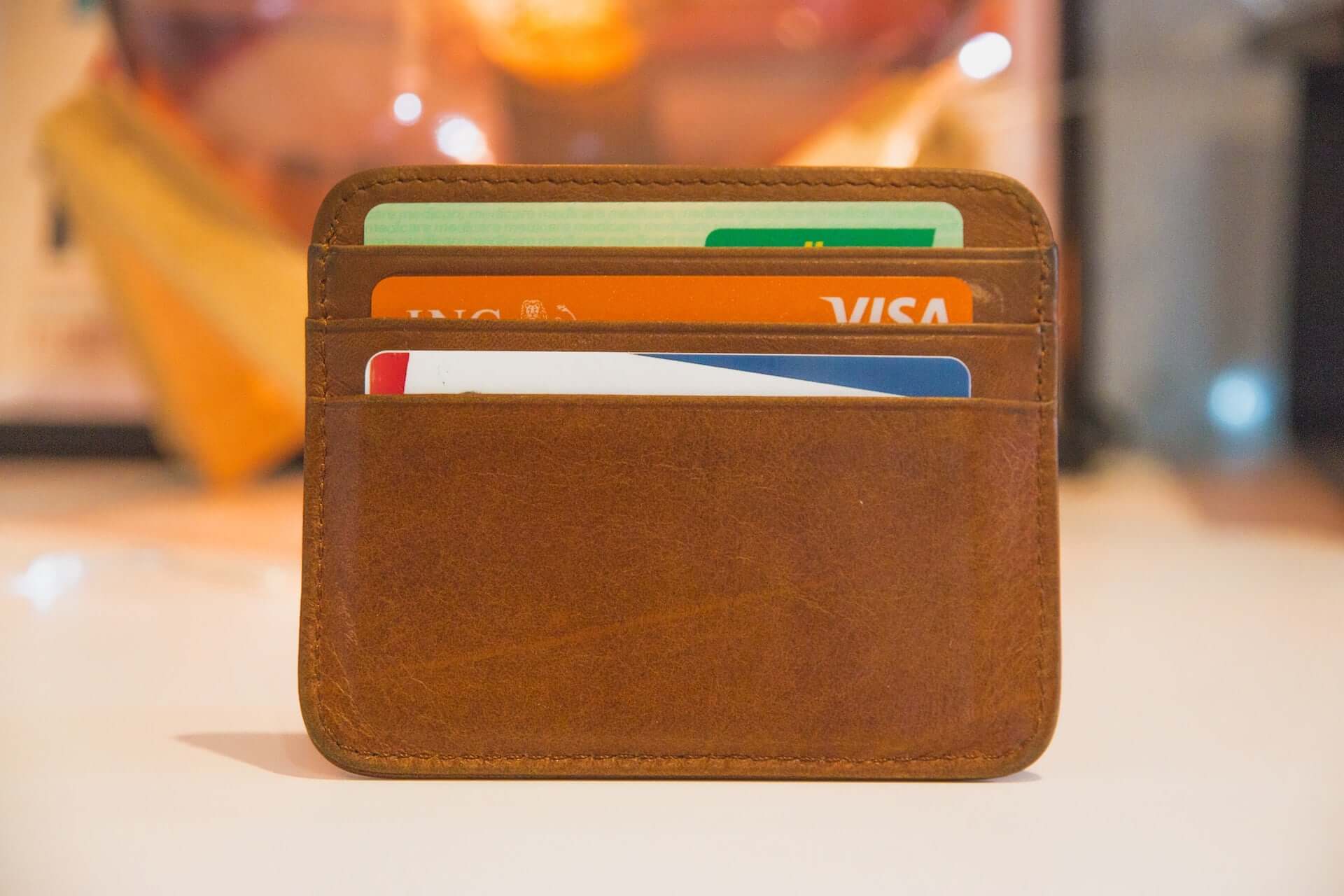 A cardholder wallet with three cards in it.