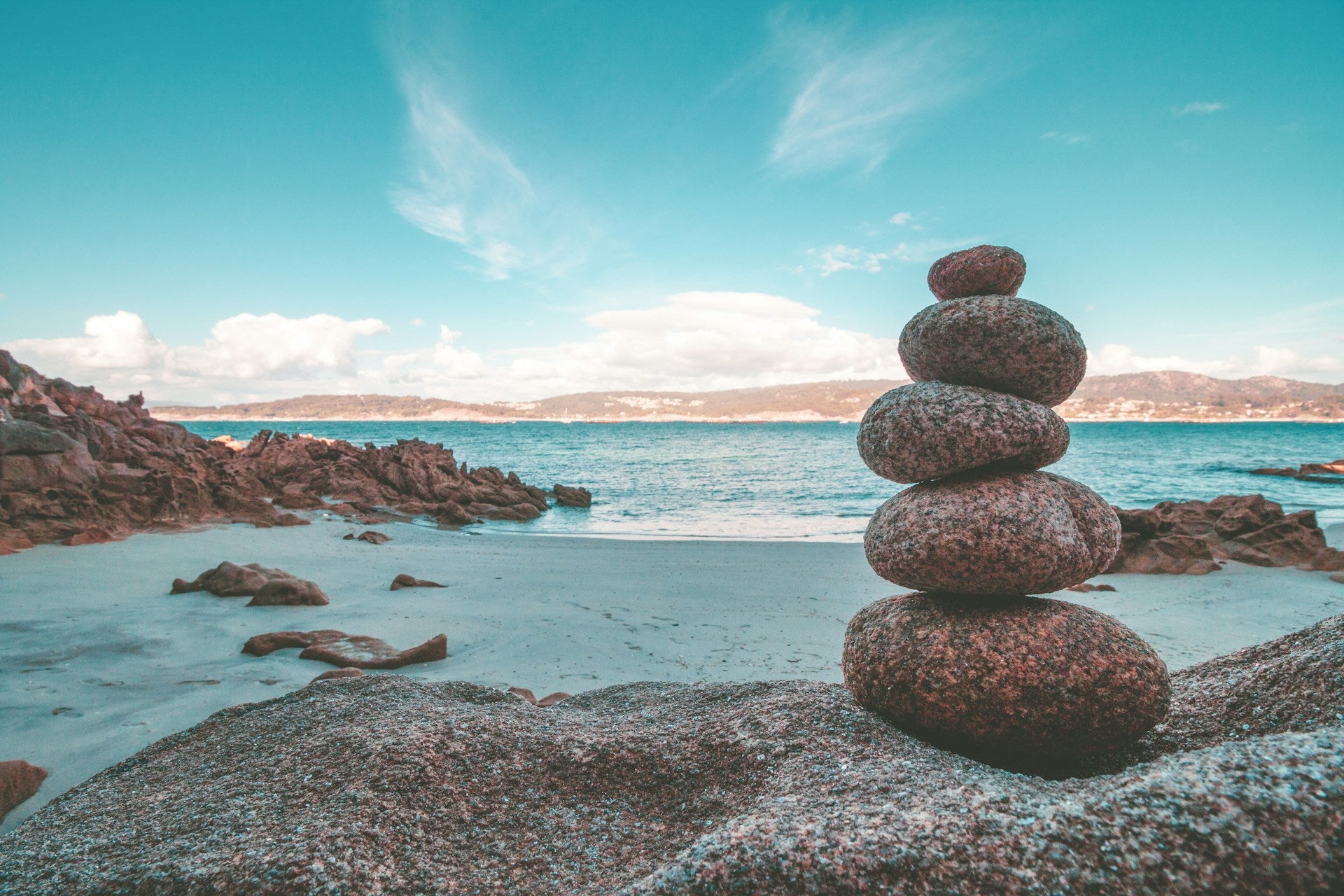A stone cairne on a beach.
