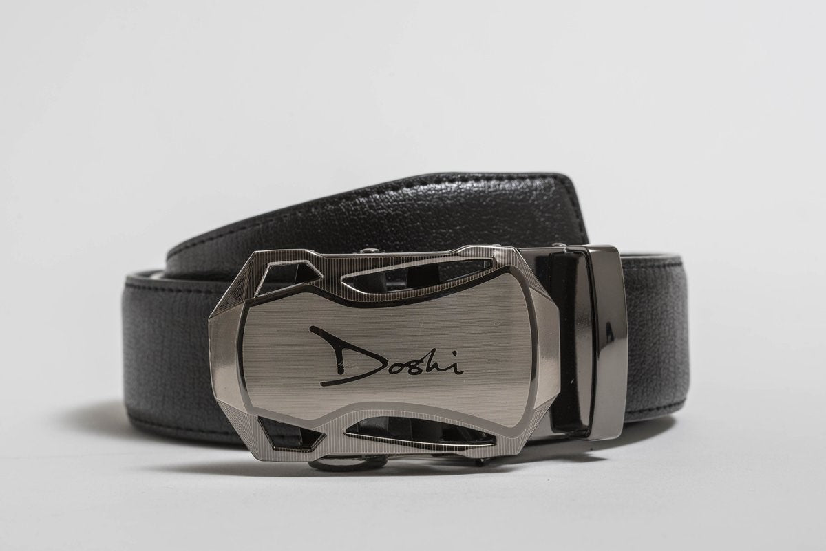 The Doshi Auto 1 Belt; a black vegan leather belt with a thick brushed silver auto buckle.