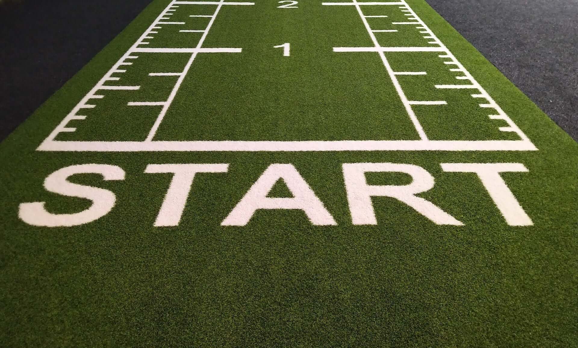 A starting line on green turf.