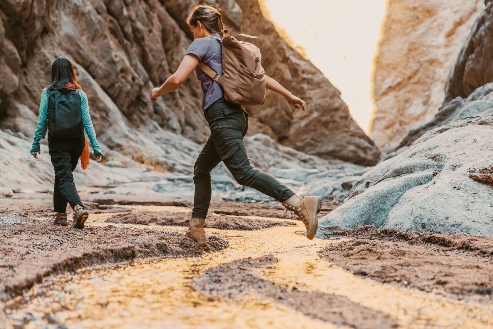 Two women hiking in a canyon.