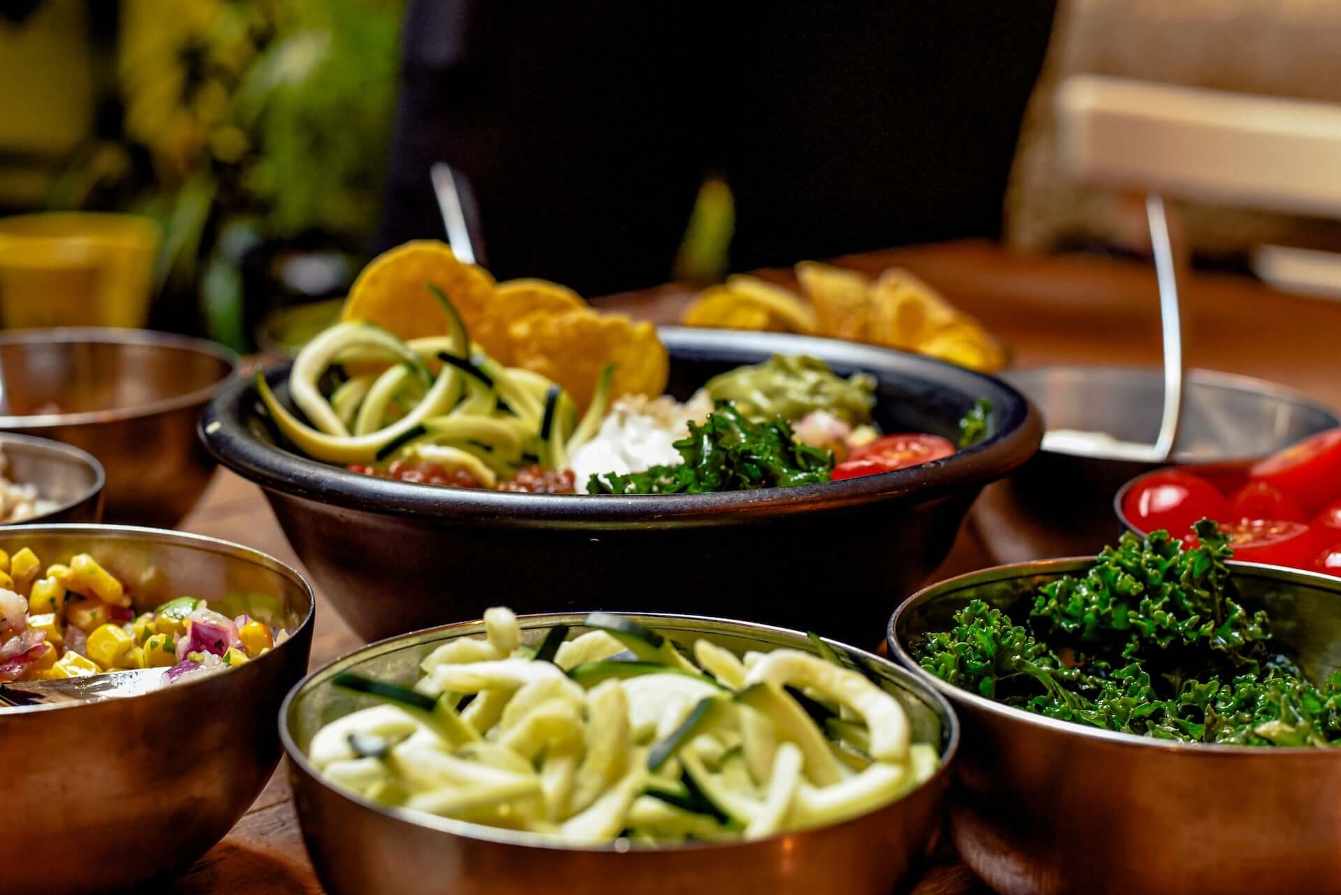 A table covered in bowls of various vegetable dishes.