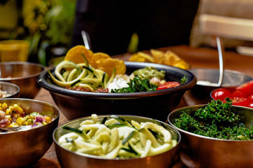 A table covered in bowls of various vegetable dishes.