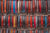 A wall of hanging belts in various colors and styles.