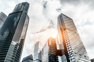 Low-angle shot of skyscrapers on a cloudy day.