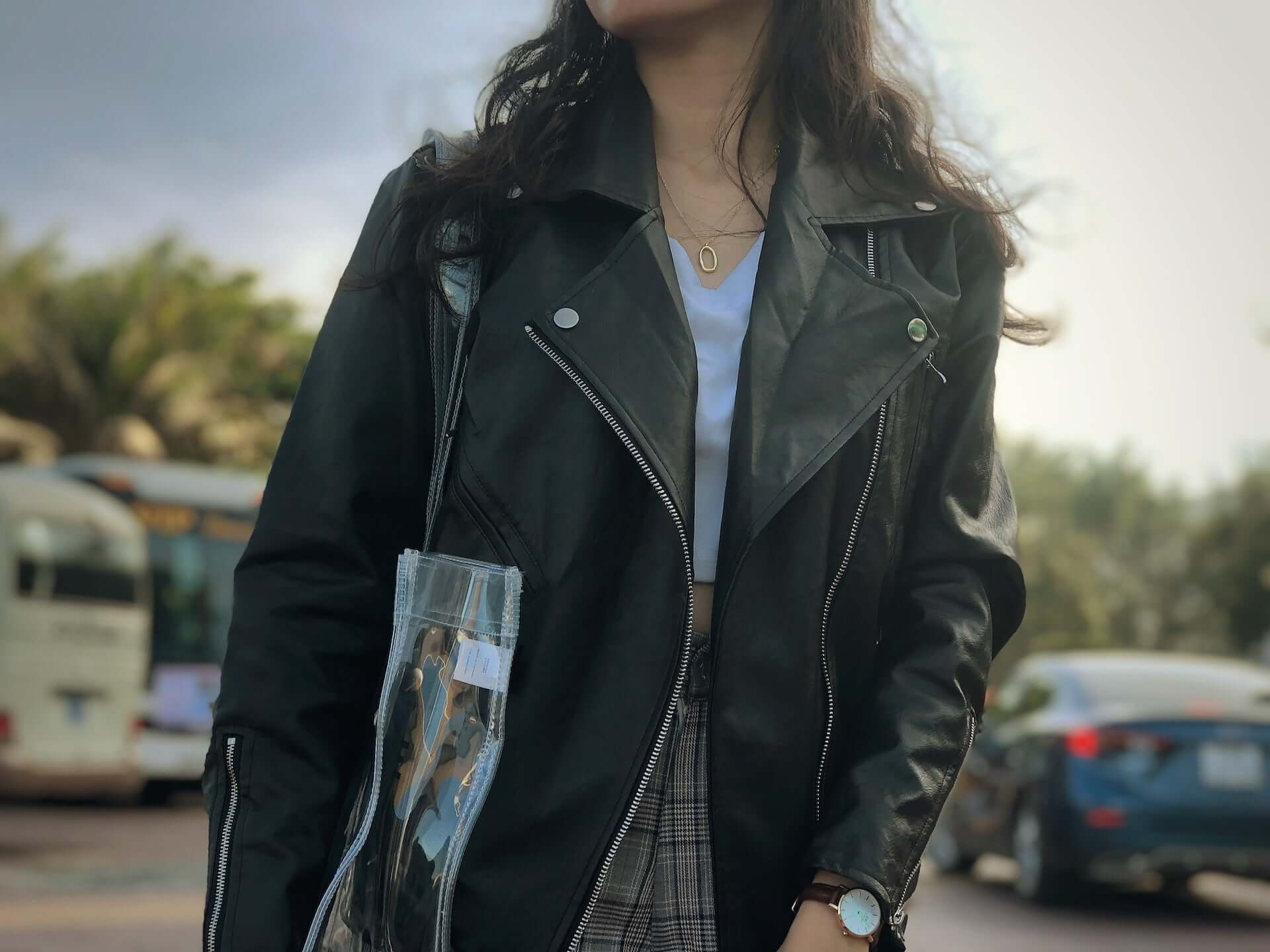 A woman wearing a black leather jacket.
