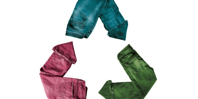 A "Recycling" symbol made of three pairs of jeans, colored blue, pink, and green.