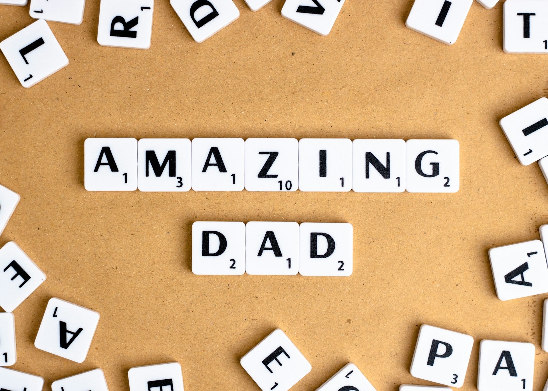 Word tiles spelling out "Amazing Dad."