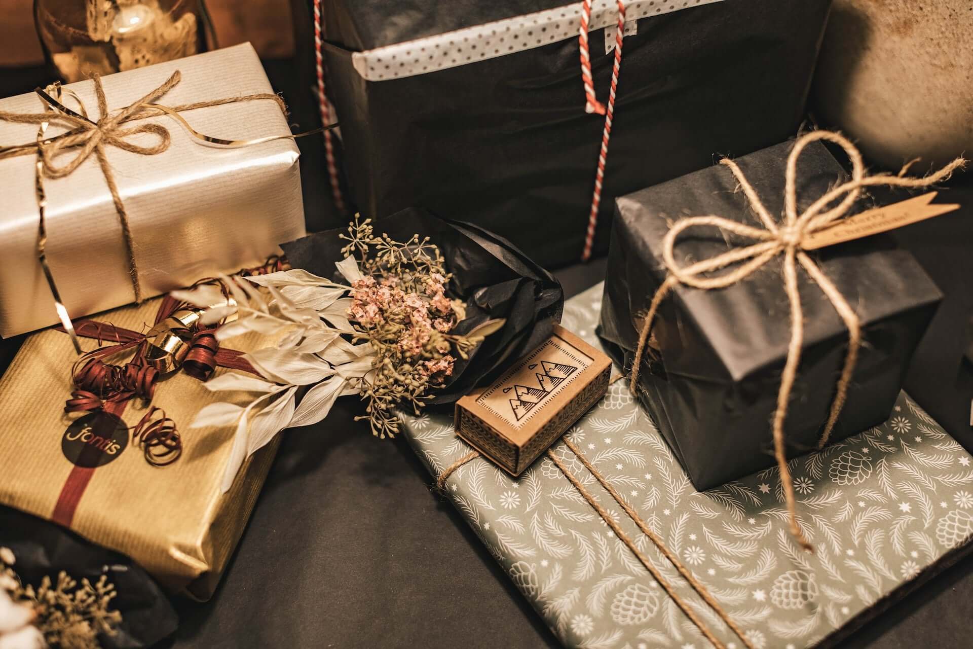 A series of gifts with earth-toned wrapping.