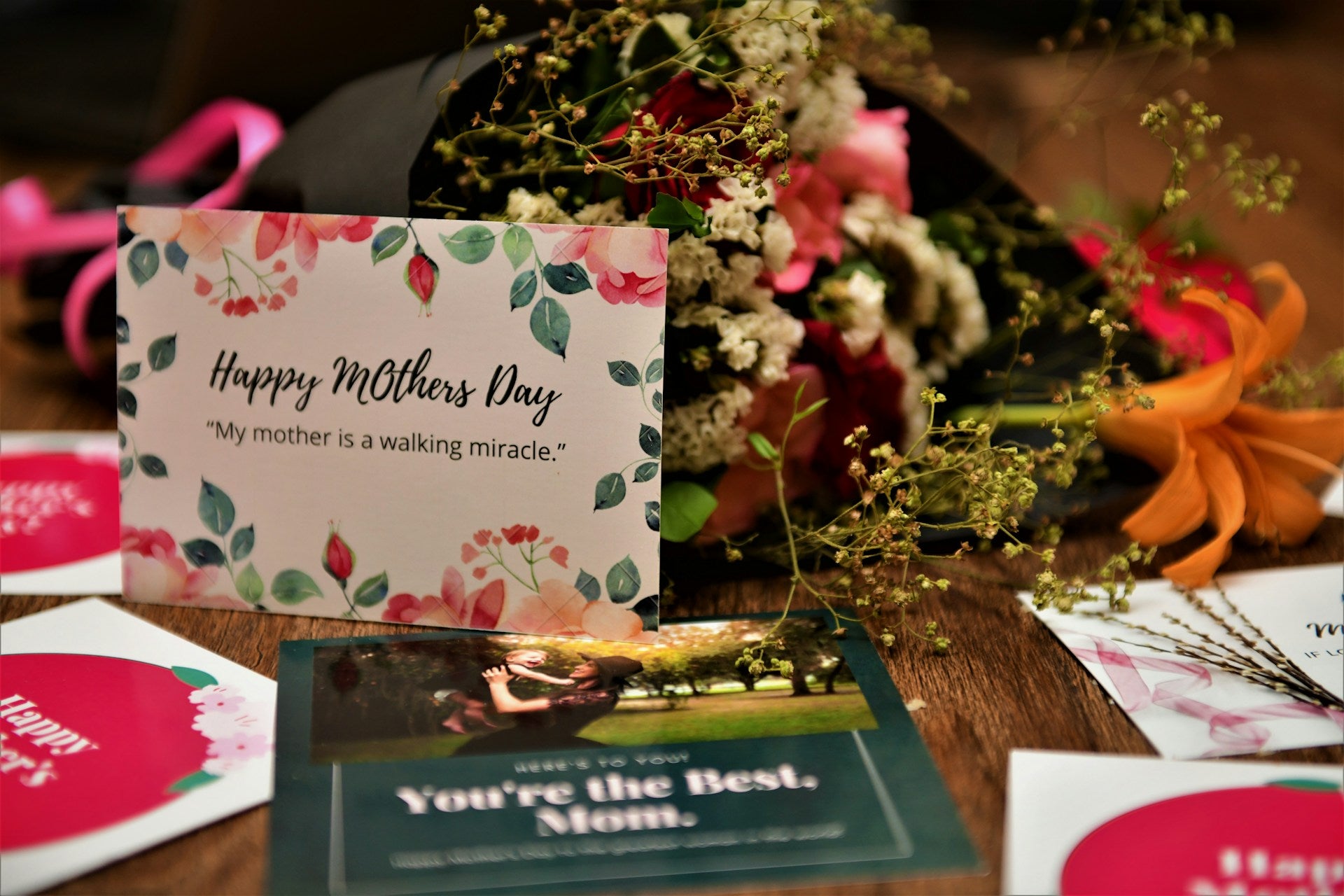 A Happy Mother's Day card and flowers on a table. 