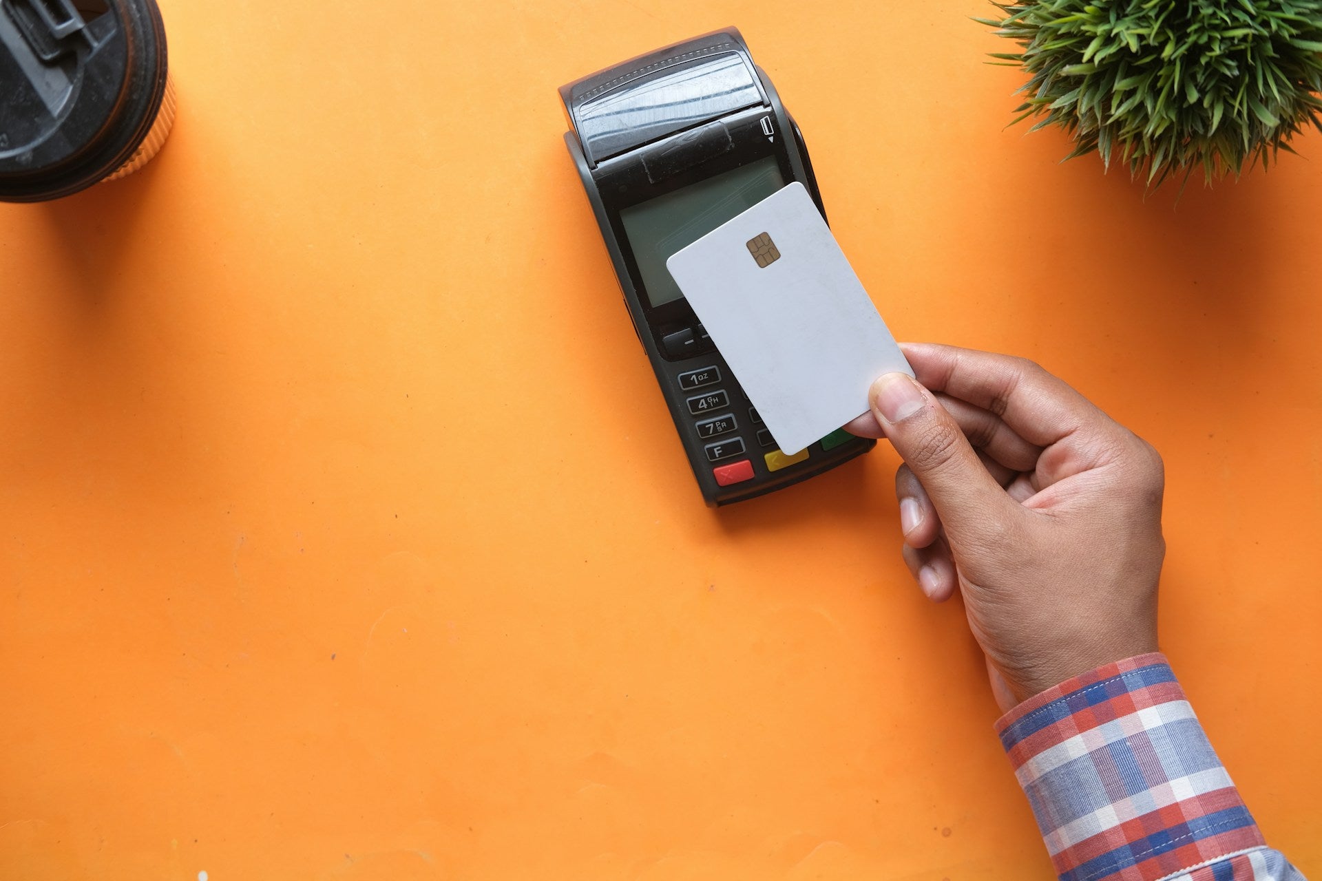 A person taps a card on a reader.